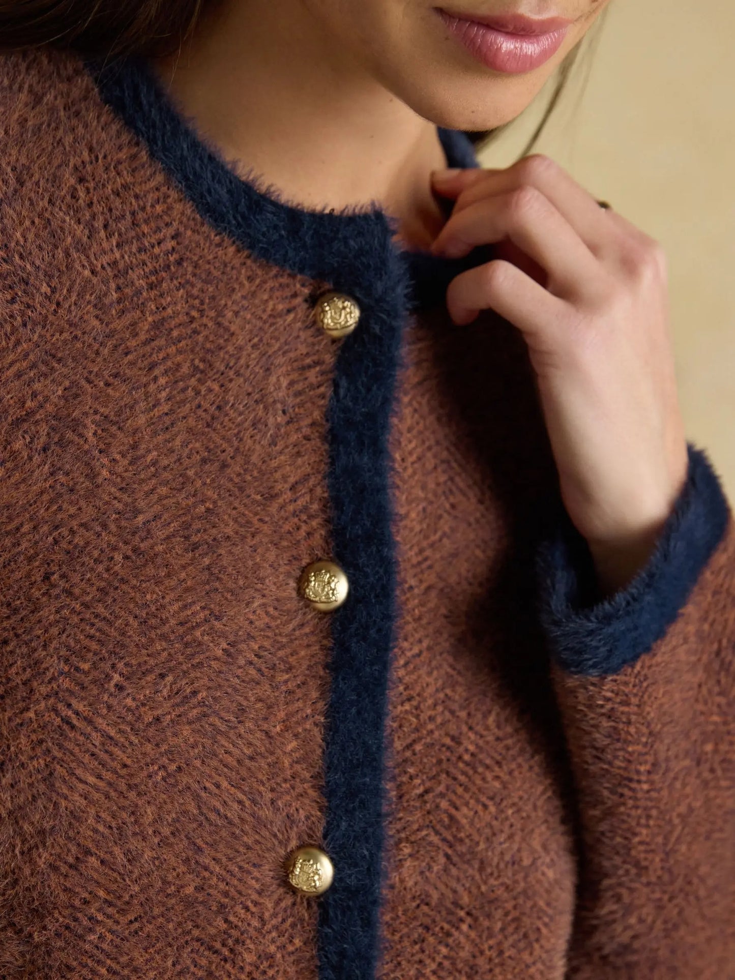 Brown knit cardigan with contrast trim and button closure