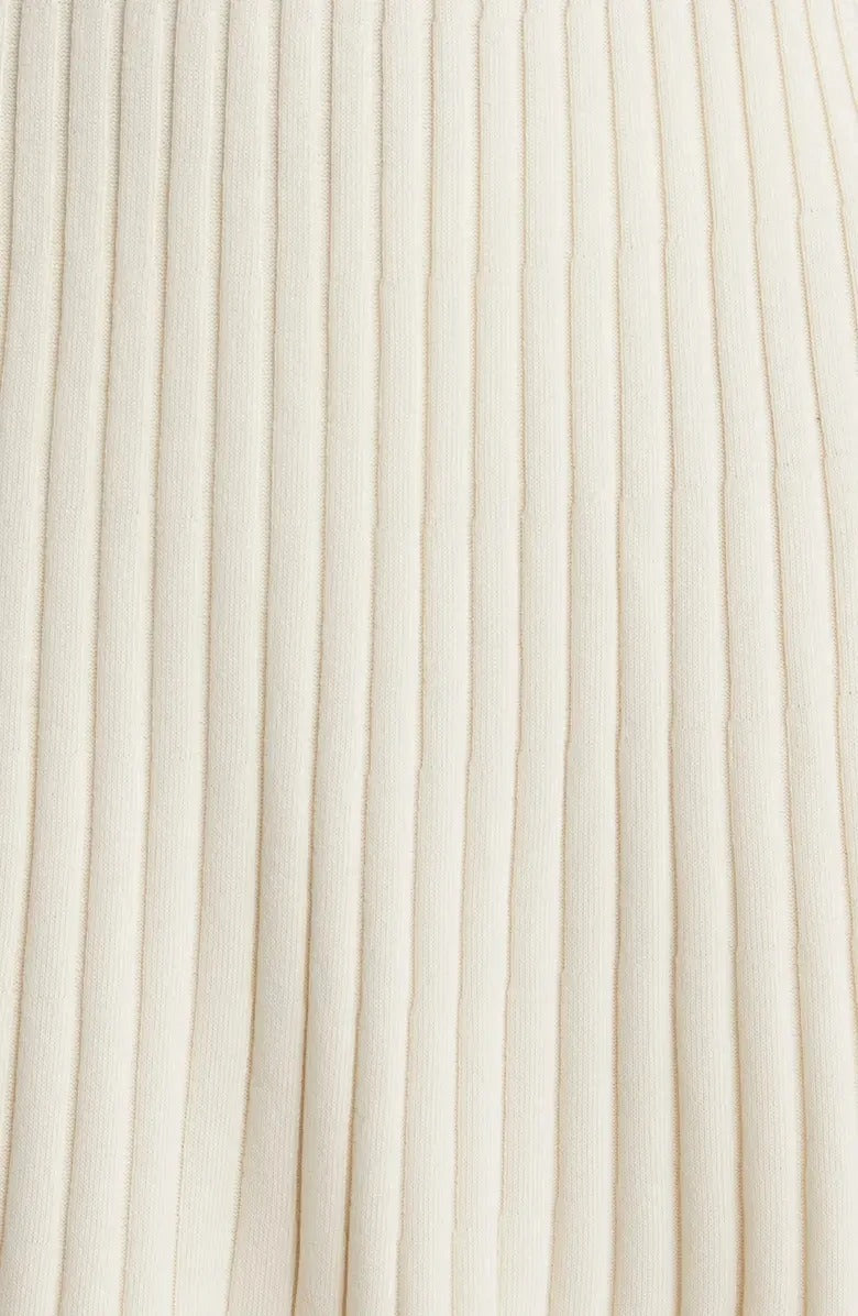 Cream ribbed knit dress with long sleeves and ruffle hem