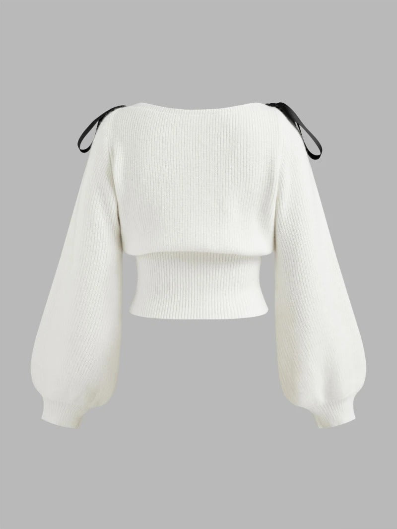 Cream knit sweater with bow shoulder ties and long sleeves