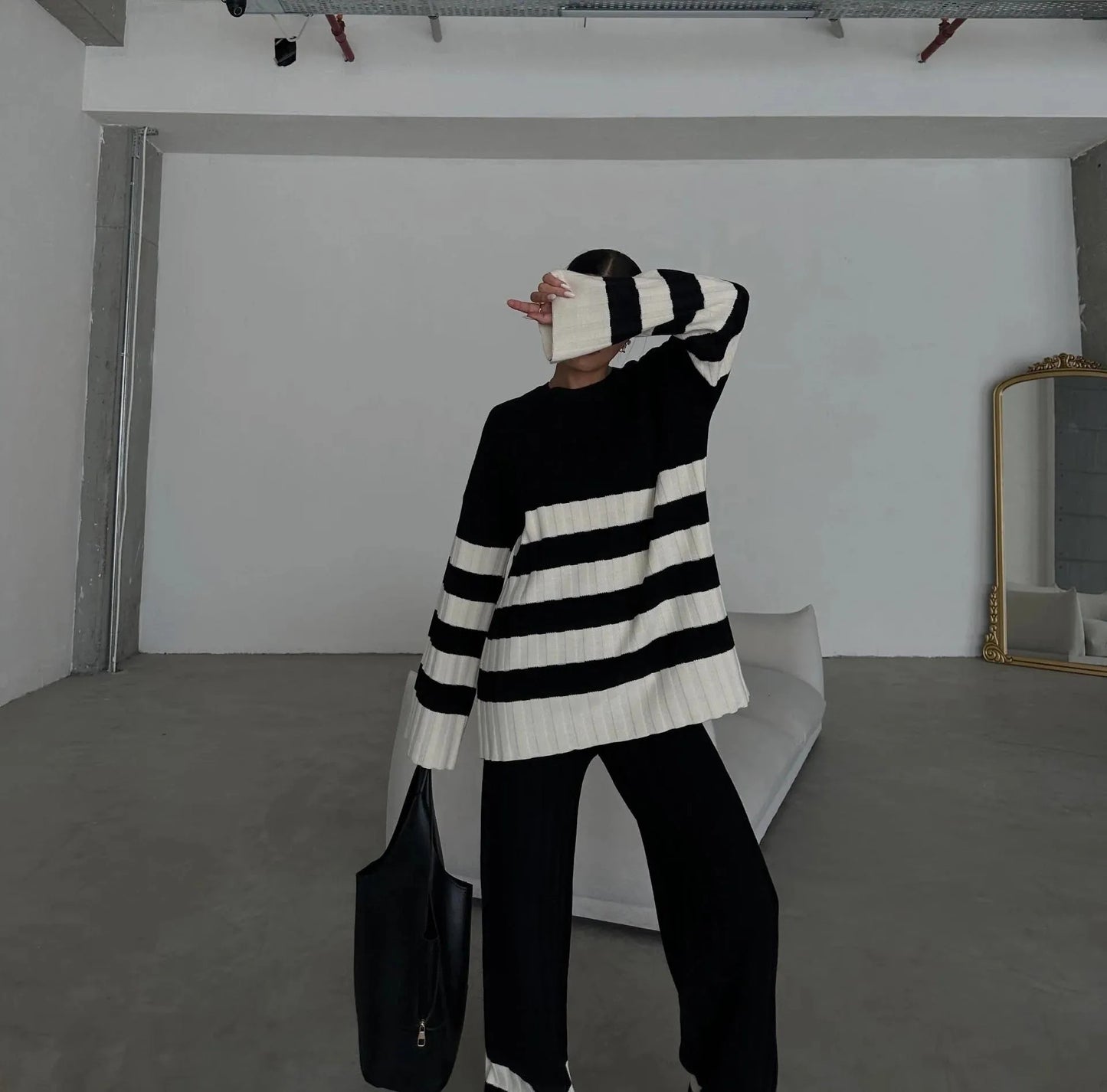 Black and cream striped knit set with sweater and wide-leg pants