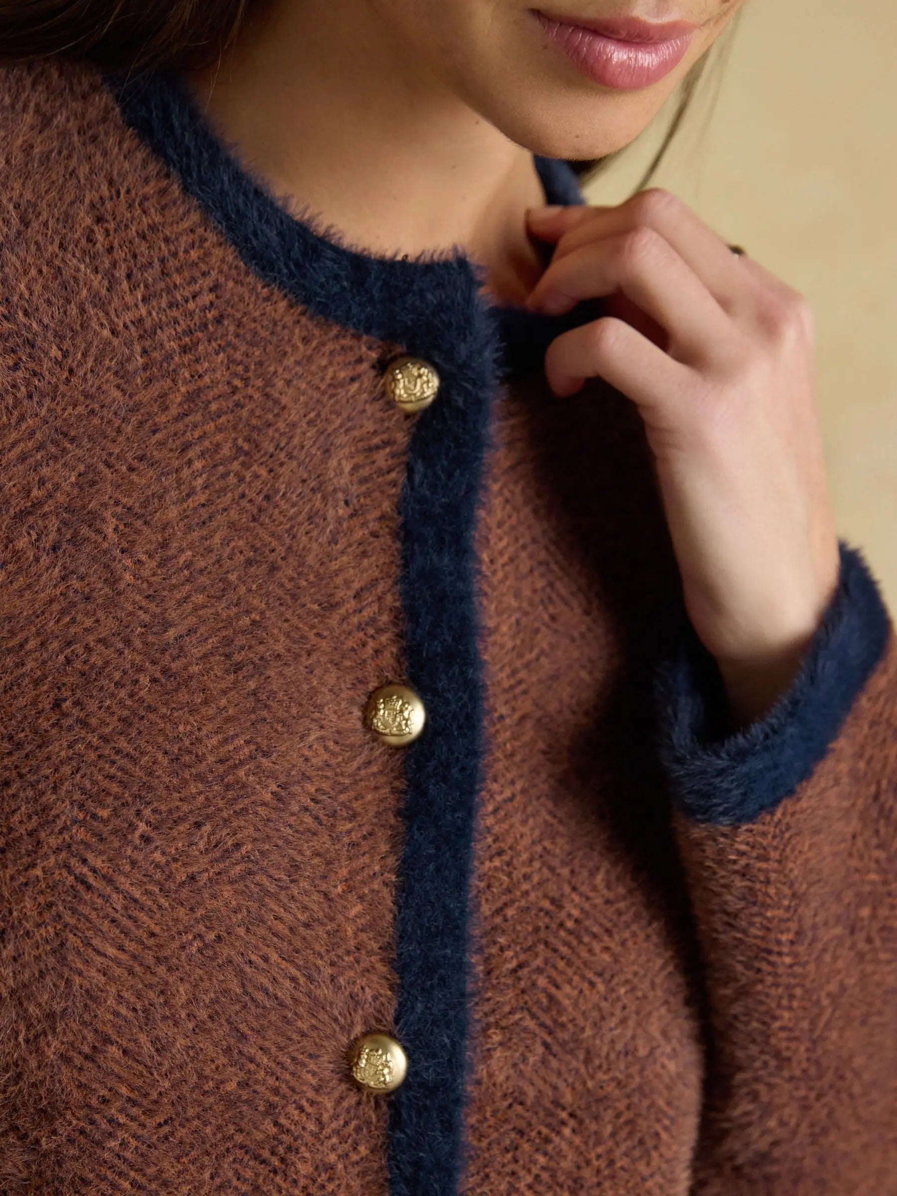 Brown knit cardigan with contrast trim and button closure