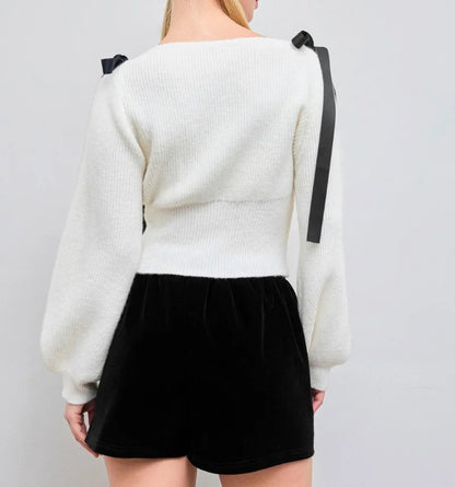 Cream knit sweater with bow shoulder ties and long sleeves