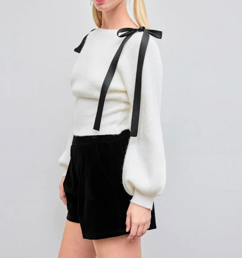 Cream knit sweater with bow shoulder ties and long sleeves