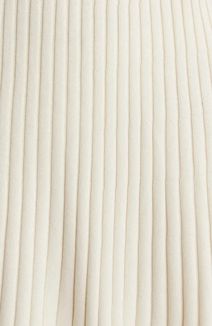 Cream ribbed knit dress with long sleeves and ruffle hem