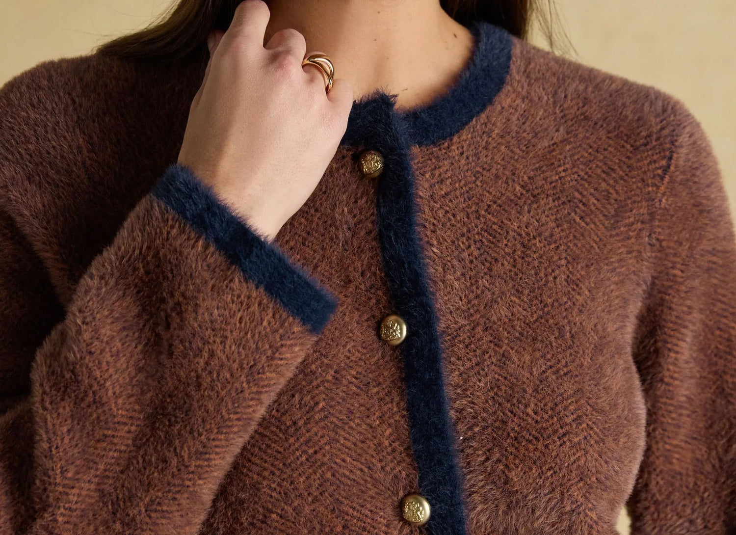 Brown knit cardigan with contrast trim and button closure